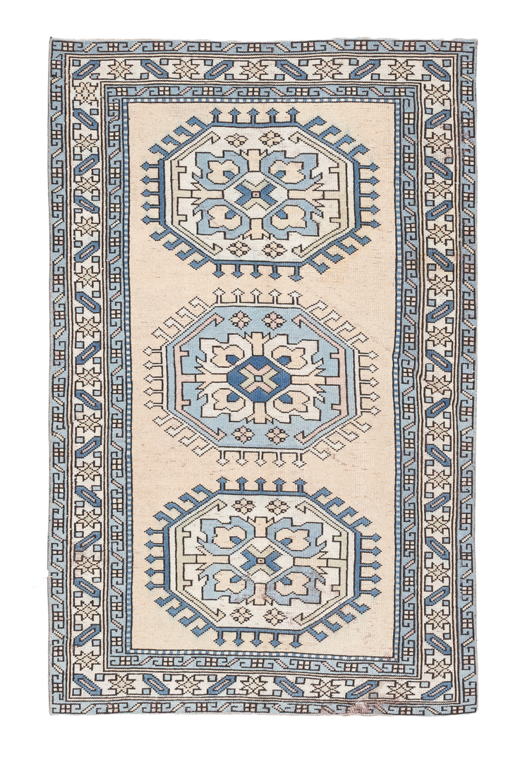 Hand-woven 3x6 ft vintage Oushak wool rug in beige and navy with traditional geometric patterns.