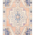 Hand-woven 4x7 ft vintage Turkish wool rug featuring an orange and beige floral medallion design in a bohemian style.