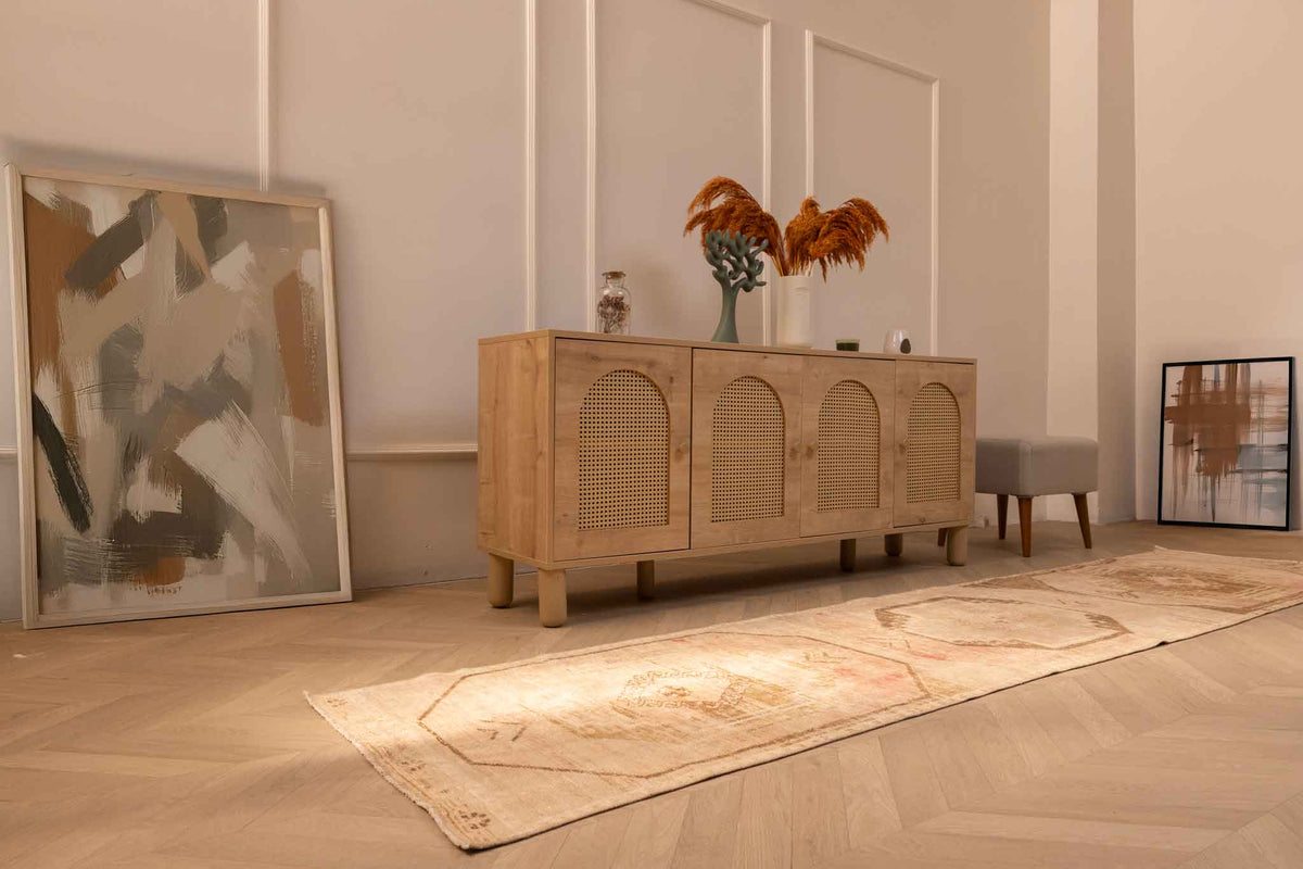 Vintage 2x11 ft handmade Turkish runner rug in beige and red with geometric patterns on a herringbone wood floor.