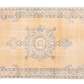 Handmade vintage Isparta runner rug in yellow and beige wool with traditional floral medallion patterns.