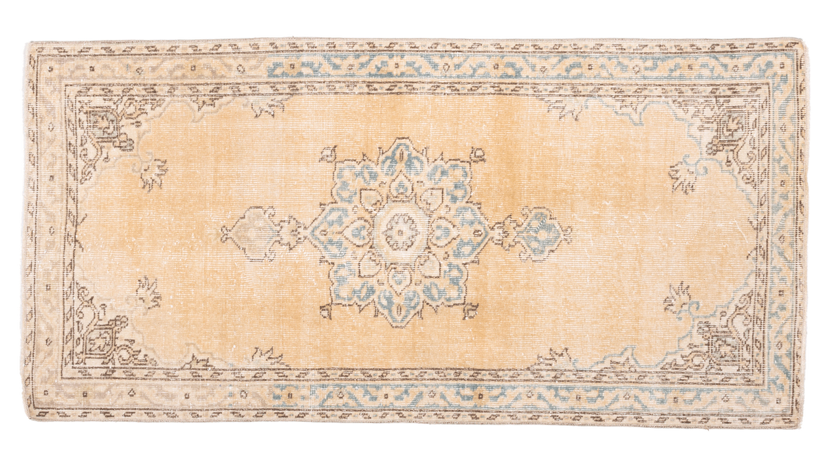 Handmade vintage Isparta runner rug in yellow and beige wool with traditional floral medallion patterns.