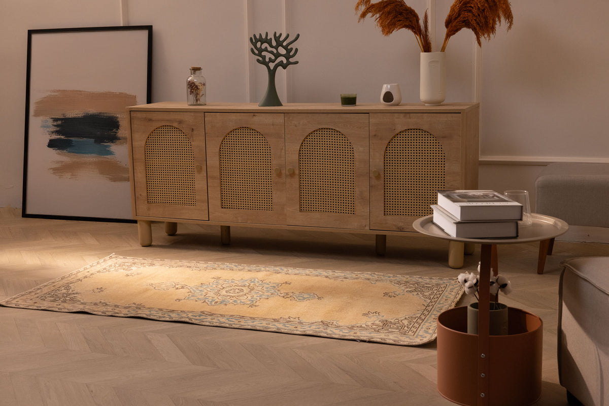 Handmade vintage Isparta runner rug in yellow and beige with traditional floral patterns on a wooden floor.