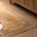 Handmade vintage yellow Isparta Turkish runner rug with floral patterns in wool and cotton on a herringbone floor.