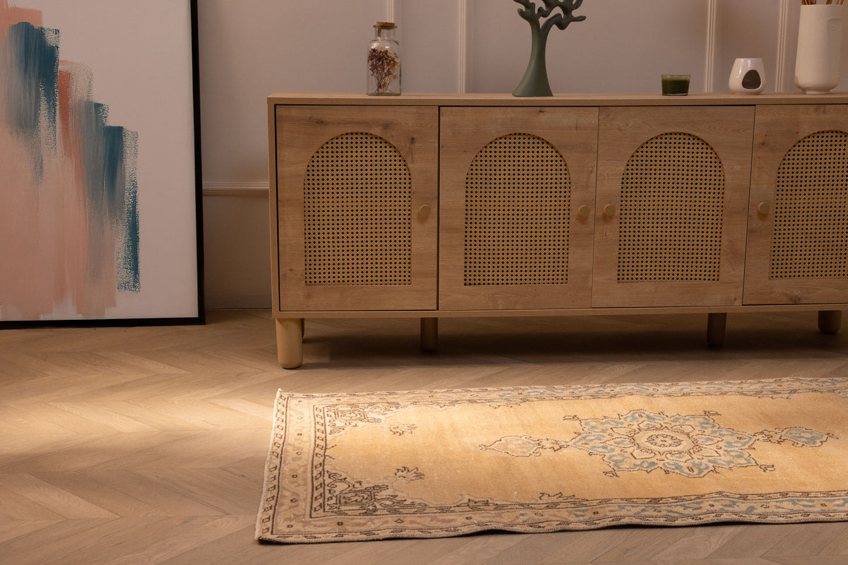 Handmade vintage Isparta Turkish runner rug in yellow and beige wool with traditional floral patterns.