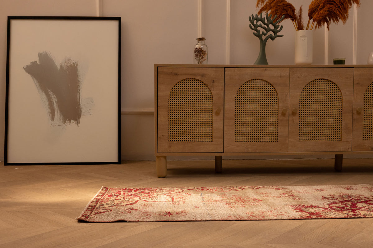 Vintage red floral Isparta Turkish runner rug in wool and cotton on a wooden floor in a bohemian interior.