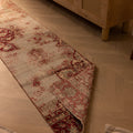 Vintage handmade Isparta Turkish runner rug in red and white floral wool and cotton on a herringbone wood floor.