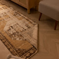 Vintage 2x10 ft beige and brown geometric Turkish runner rug with a hand-woven wool and cotton low-pile texture.