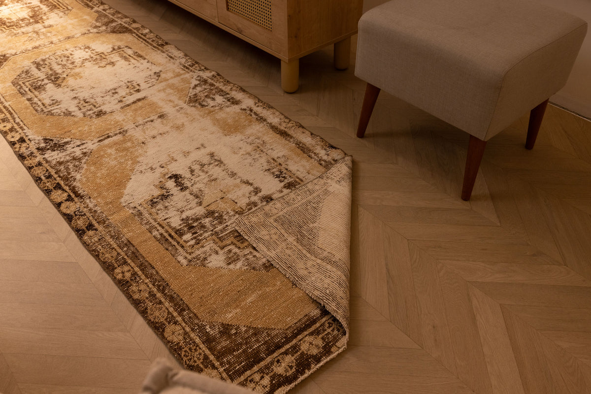 Vintage 2x10 ft beige and brown geometric Turkish runner rug with a hand-woven wool and cotton low-pile texture.