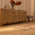 Vintage 2x4 ft orange floral Turkish Isparta wool and cotton area rug on a wooden floor in a bohemian room.