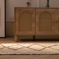 Handmade 2.9x7.6 ft wool and cotton runner rug in white and brown with a geometric farmhouse pattern.