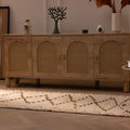 Handmade white and brown wool-cotton Persian-style runner rug with geometric patterns on a wooden floor.