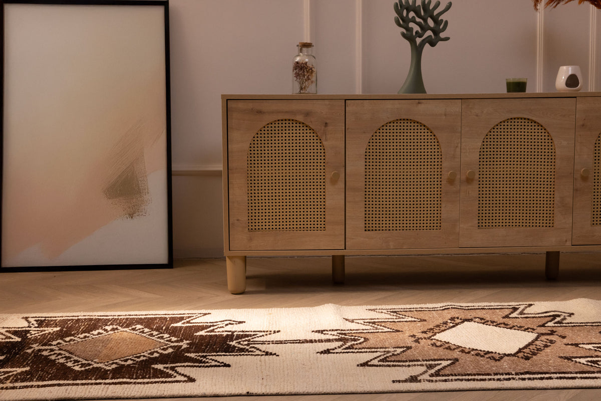 Handmade white and brown wool-cotton Persian-style runner rug with geometric patterns in a farmhouse interior.