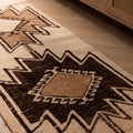 Handmade 2.9x10.8 ft wool and cotton runner rug featuring white and brown geometric patterns in a farmhouse style.