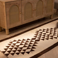 Handmade white and brown geometric wool-cotton runner rug, 3.3 x 10.4 ft, featuring a farmhouse-style flatweave design.