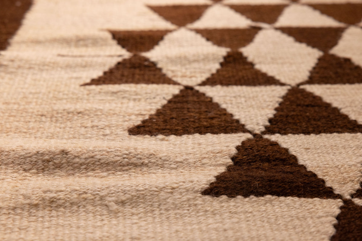 Handmade white and brown wool-cotton flatweave runner rug featuring a geometric triangle pattern in farmhouse style.