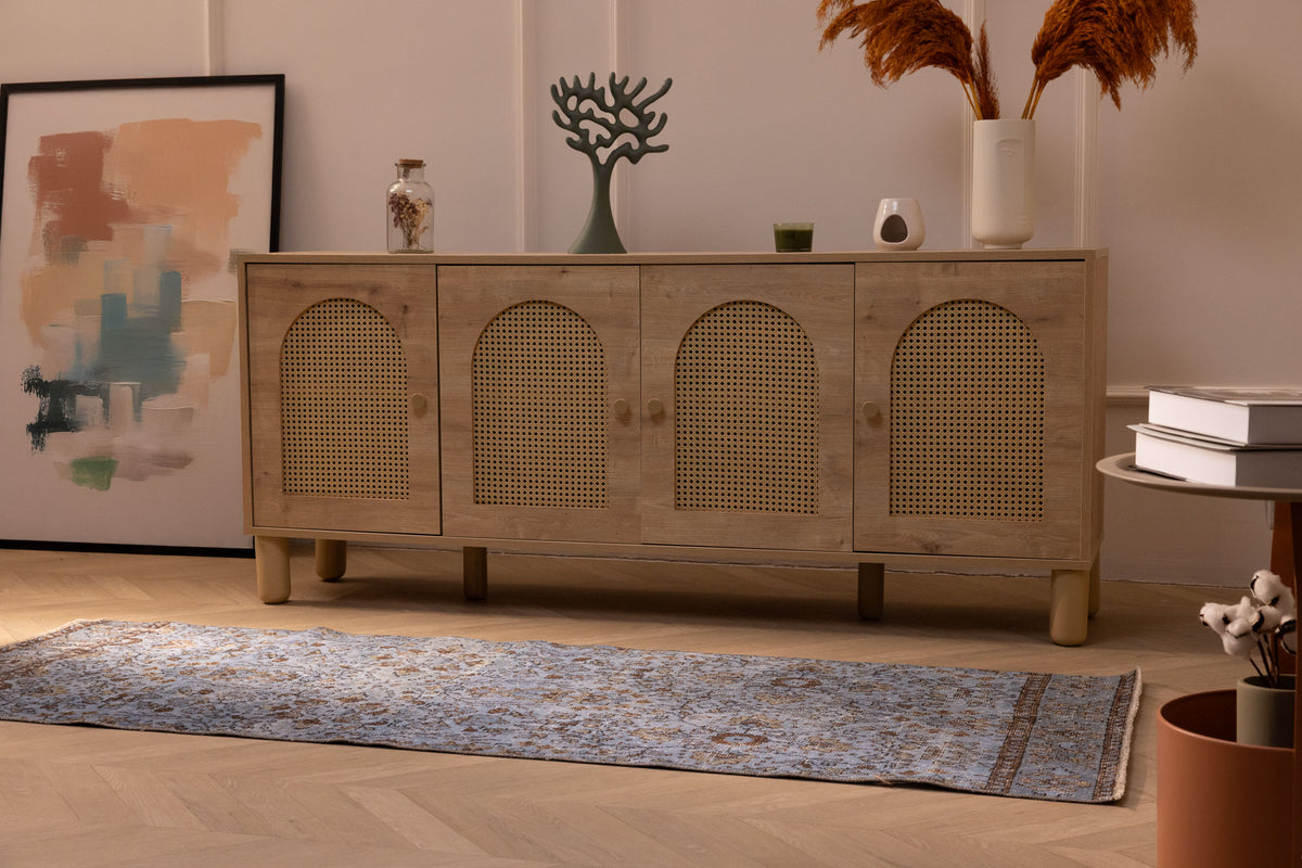 Vintage navy overdyed Turkish runner rug with intricate floral patterns in a bohemian hallway setting.