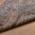 Vintage navy overdyed Turkish runner rug with floral patterns, handmade from wool and cotton on a wooden floor.