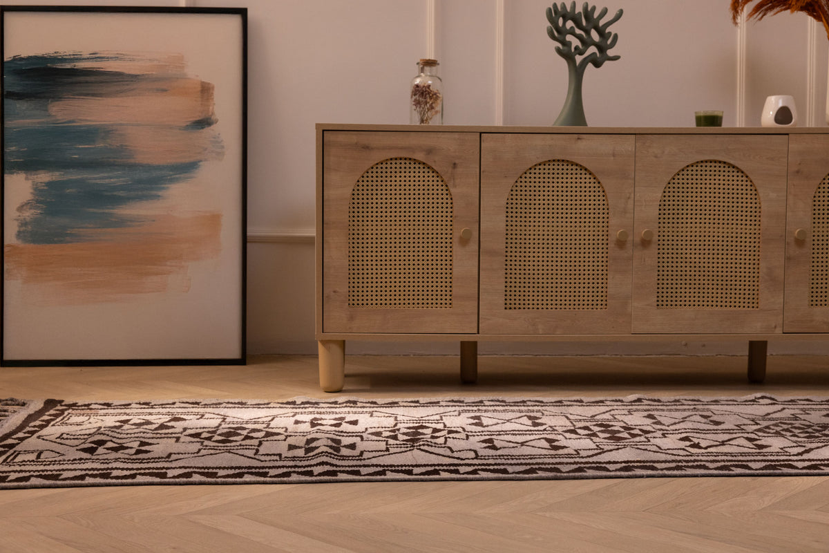 Handmade gray and brown Persian-style wool and cotton kilim runner with geometric patterns on a wooden floor.