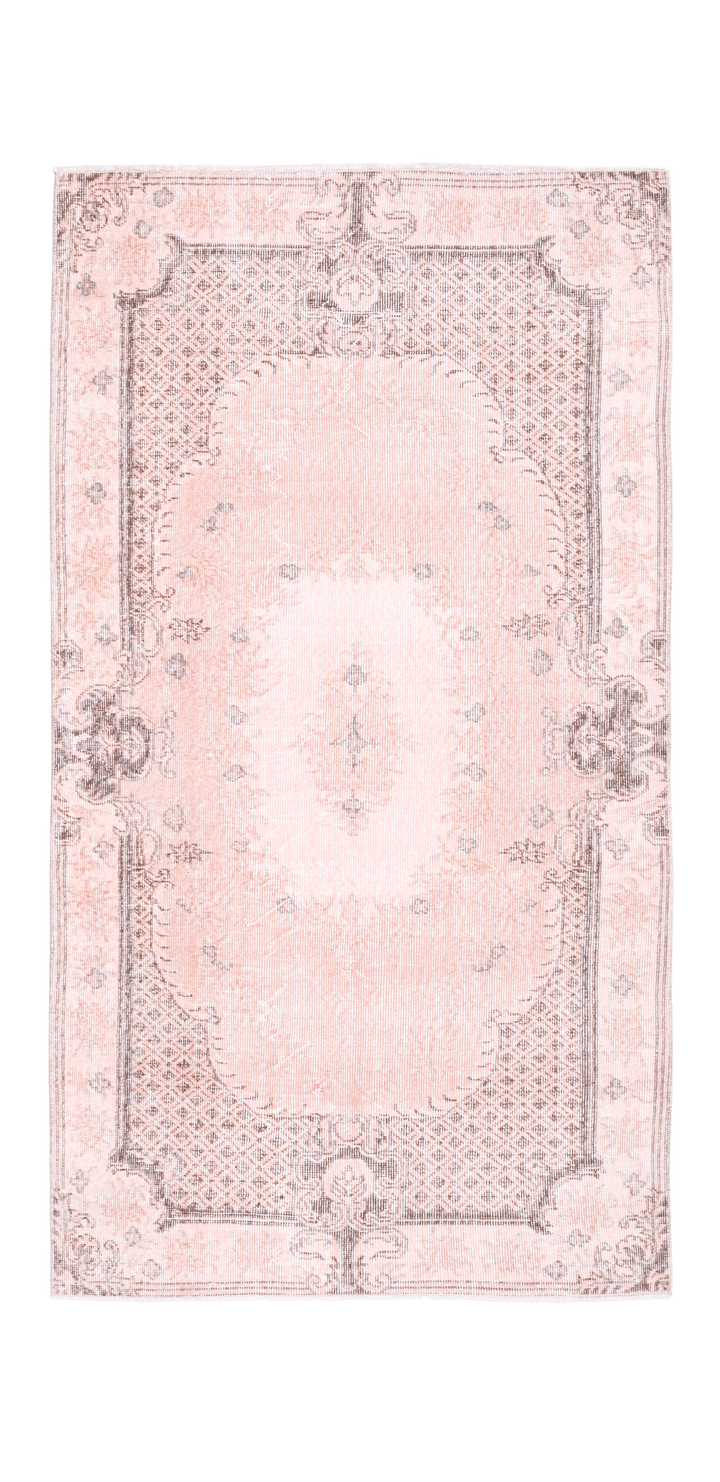 Hand-woven 3x6 ft vintage pink overdyed Turkish Isparta rug with intricate floral patterns and a wool-cotton blend.