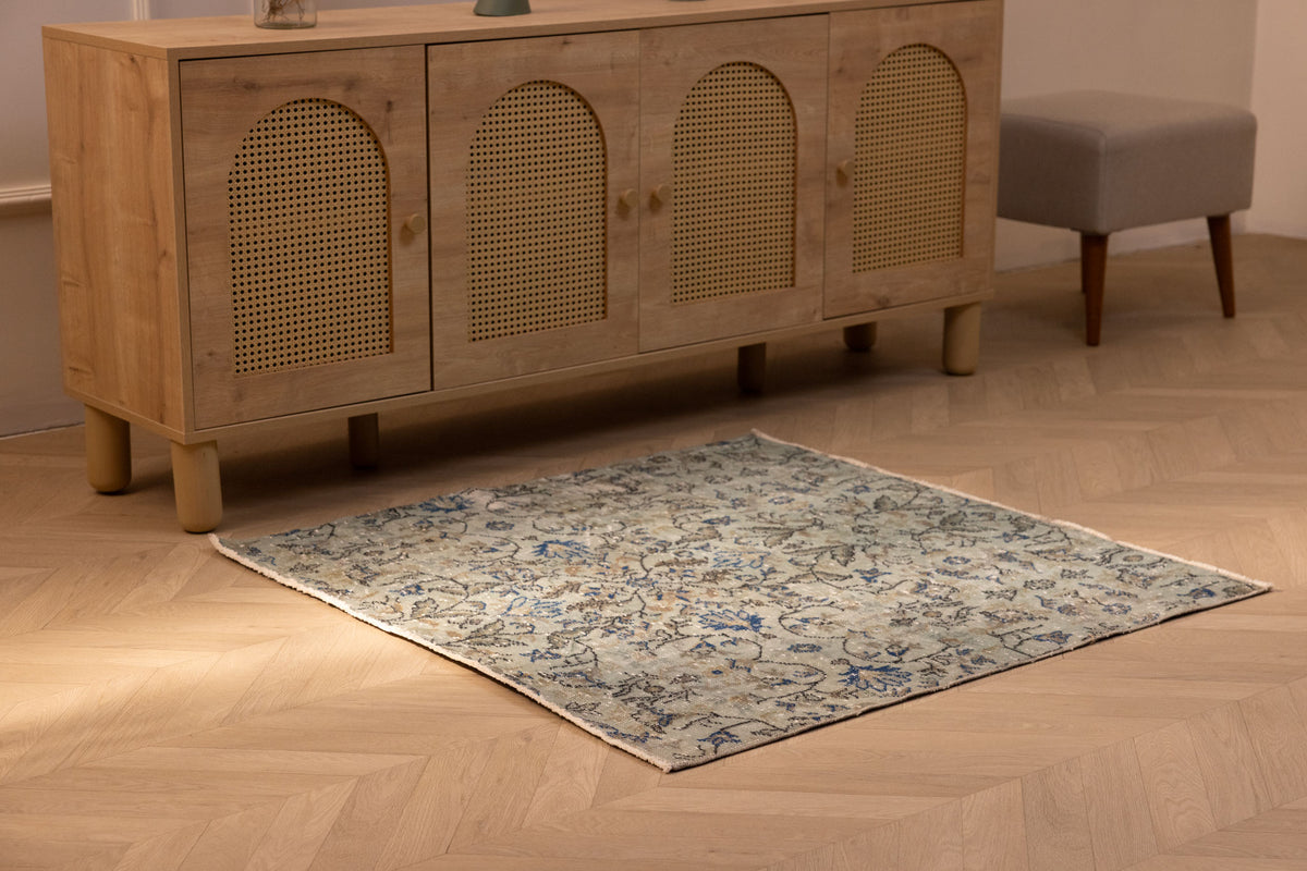 Hand-woven 3x4 ft vintage Isparta wool and cotton rug in gray and navy with a bohemian floral pattern.
