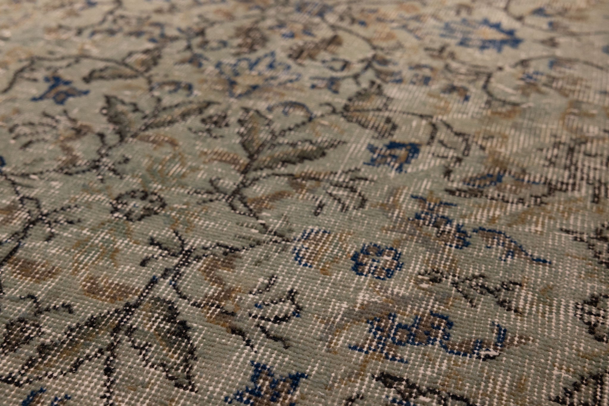 Hand-woven vintage Isparta wool and cotton rug in gray and navy with a detailed bohemian floral pattern.
