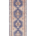 Handwoven 4x12 ft vintage Turkish runner rug in orange and navy with geometric tribal patterns and wool-cotton blend.