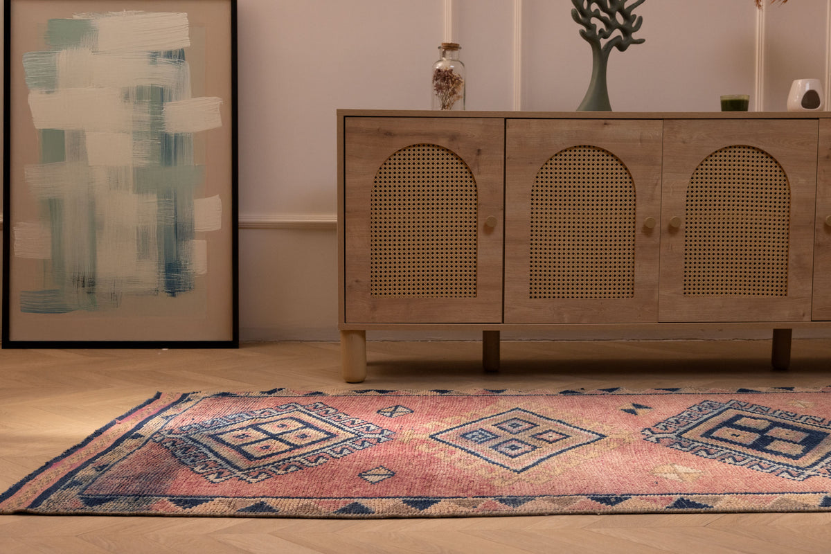 Handmade 3.5x9.9 ft wool and cotton runner rug featuring pink and navy geometric patterns in a bohemian style.