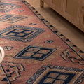 Handmade 3.5x9.9 ft wool and cotton runner rug in pink and navy with bohemian geometric patterns.