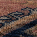 Close-up of a handmade wool and cotton Persian-style runner rug with pink and navy geometric bohemian patterns.