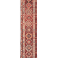 Handmade 2.9x12.5 ft wool and cotton Persian-style runner rug with red, brown, and geometric floral patterns.
