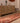 Handmade 2.9x12.5ft wool and cotton runner rug in red and brown with a bohemian geometric floral pattern.
