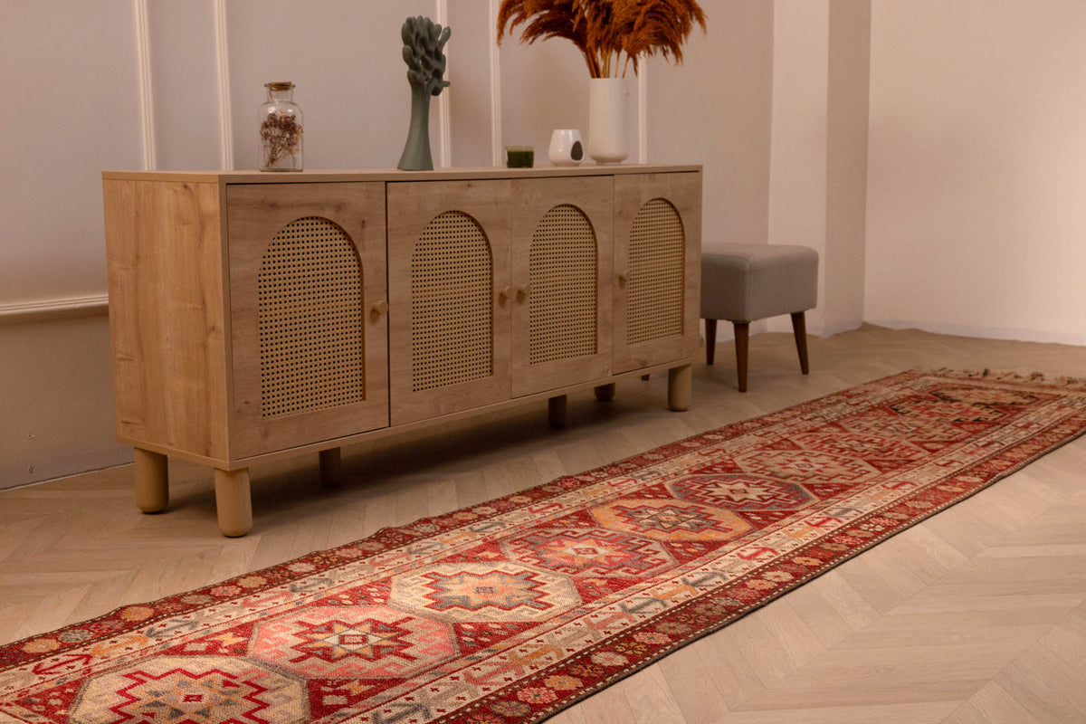 Handmade 2.9x12.5ft wool and cotton runner rug in red and brown with a bohemian geometric floral pattern.