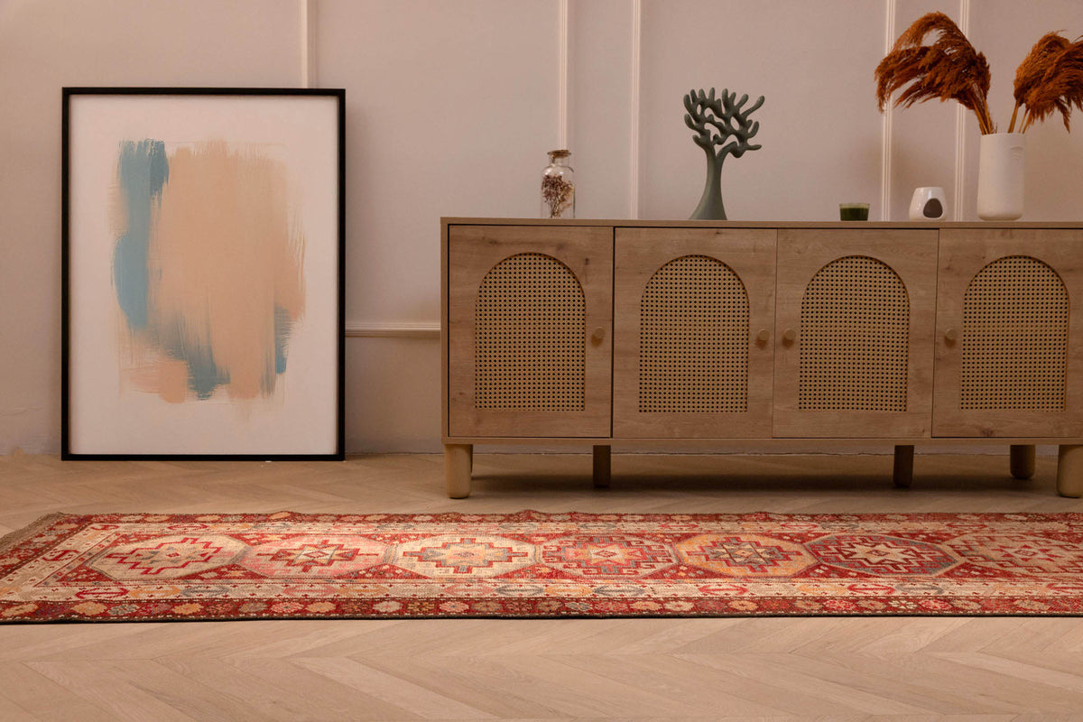 Handmade 2.9x12.5 ft wool and cotton Persian-style runner rug in red and brown with geometric floral patterns.