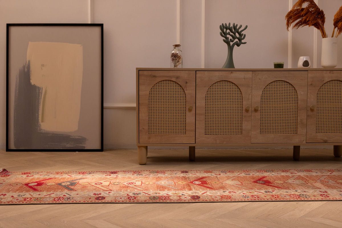 Handmade 2.5x13.4 ft wool and cotton Persian-style runner rug in brown and beige with bohemian floral and geometric patterns.