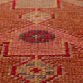 Handmade wool and cotton Persian-style runner rug featuring brown and beige geometric floral patterns in a bohemian design.