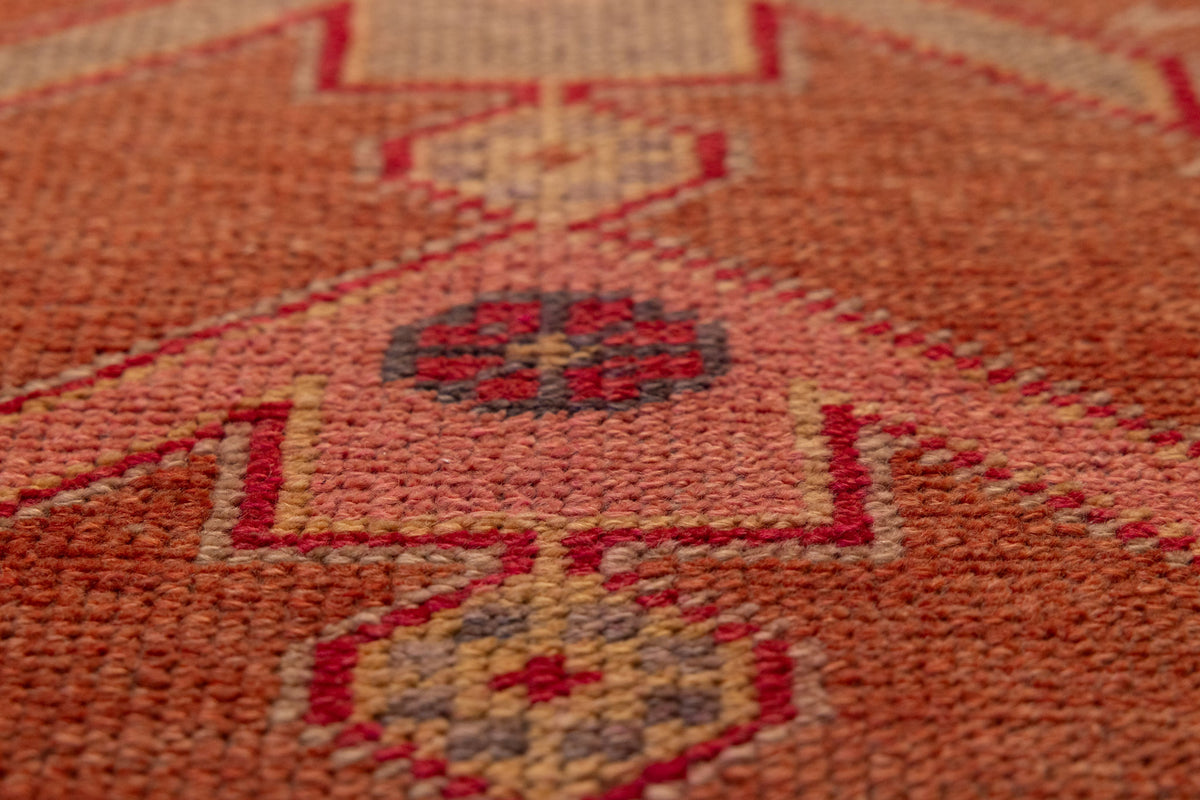 Handmade wool and cotton Persian-style runner rug featuring brown and beige geometric floral patterns in a bohemian design.