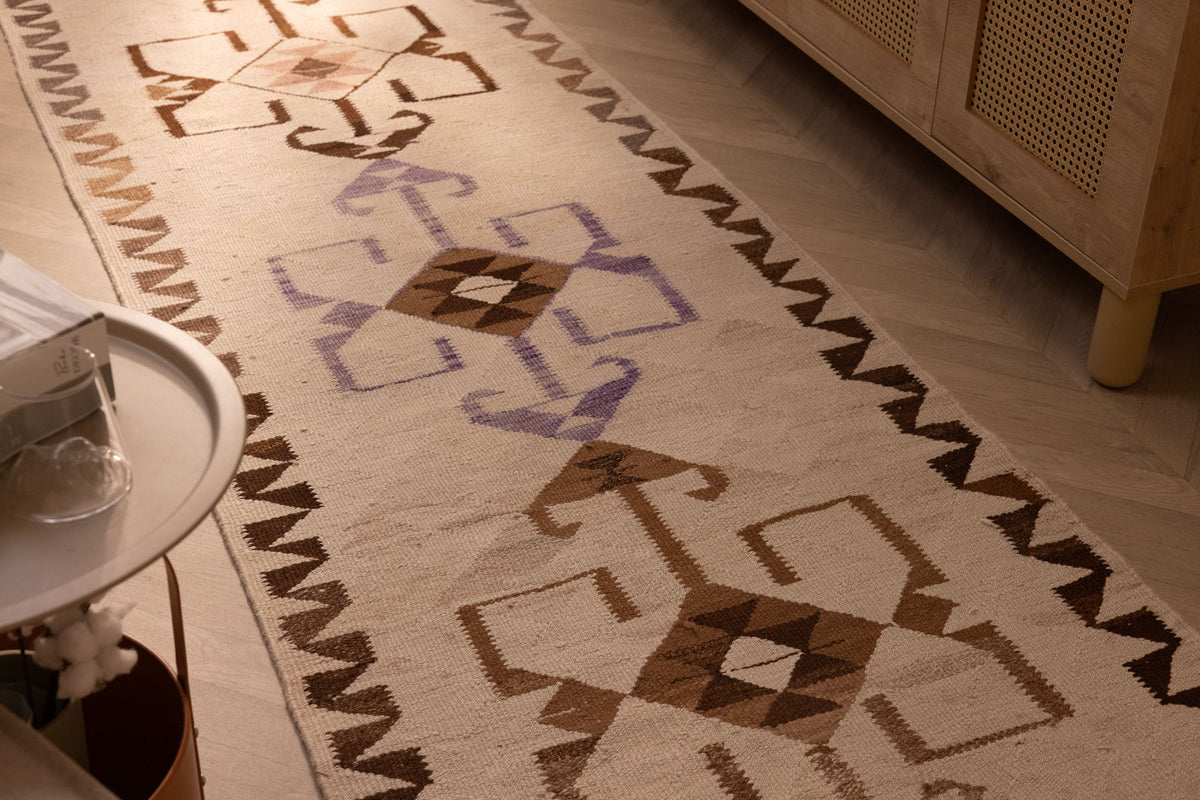 Handmade 3x11 ft Persian-style wool and cotton kilim runner with white and brown geometric patterns in a farmhouse setting.