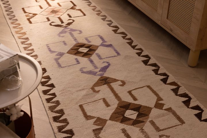 Handmade 3x11 ft Persian-style wool and cotton kilim runner with white and brown geometric patterns in a farmhouse setting.