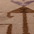 Handmade wool and cotton Persian-style Kilim runner with brown and white geometric patterns in a flatweave texture.
