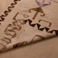 Handmade 3x11 ft wool and cotton Persian-style kilim runner with white and brown geometric patterns on a wood floor.