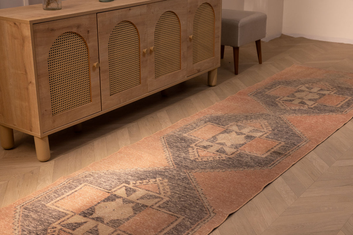 Hand-woven vintage Turkish runner rug in orange and gray geometric wool, 2x11 ft, styled in a farmhouse interior.