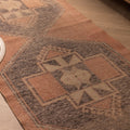 Hand-woven 2x11 ft vintage Turkish runner rug in burnt orange and gray with geometric patterns and wool-cotton blend.