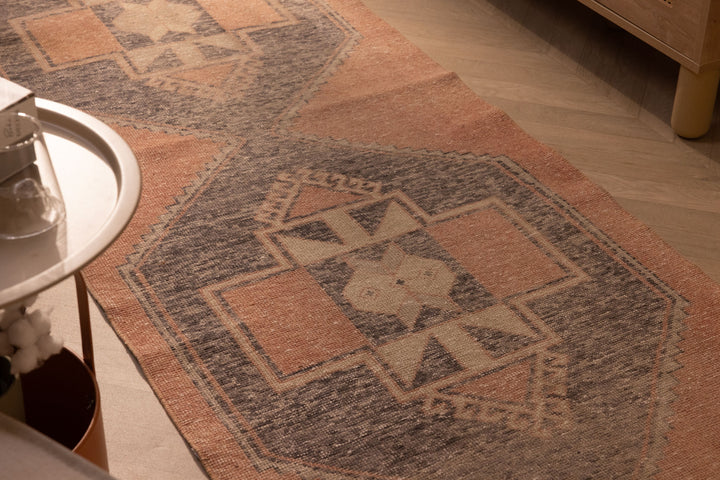 Hand-woven 2x11 ft vintage Turkish runner rug in burnt orange and gray with geometric patterns and wool-cotton blend.