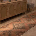 Hand-woven vintage Konya runner rug in burnt orange with floral patterns, made from wool and cotton, 12.4 ft long.