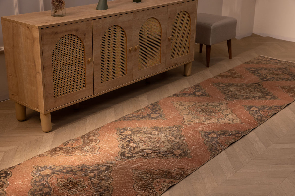 Hand-woven vintage Konya runner rug in burnt orange with floral patterns, made from wool and cotton, 12.4 ft long.