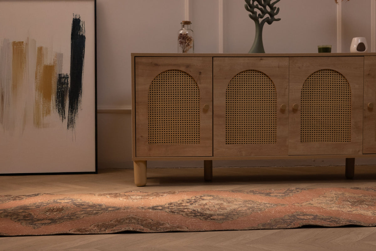 Vintage burnt-orange Konya Turkish runner rug with floral patterns in a bohemian interior.