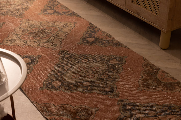 Hand-woven vintage Konya runner rug in burnt orange with floral patterns, made from wool and cotton.