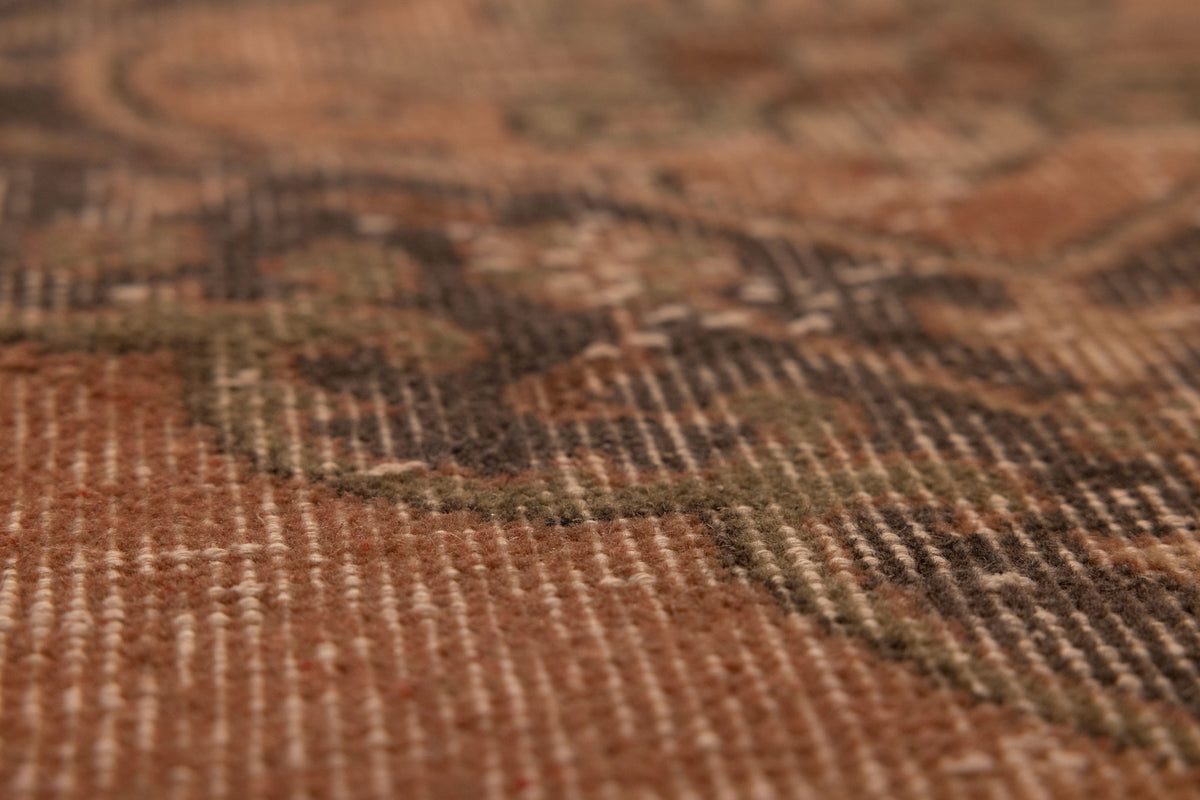 Close-up of a vintage hand-woven Konya runner rug featuring orange and dark floral patterns in wool and cotton.
