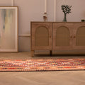 Handmade 2.9x14 ft wool and cotton Persian-style kilim runner in brown and orange with geometric patterns.