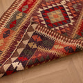 Handmade 2.9x14 ft Persian-style wool and cotton Kilim runner with geometric maximalist patterns in brown and orange.